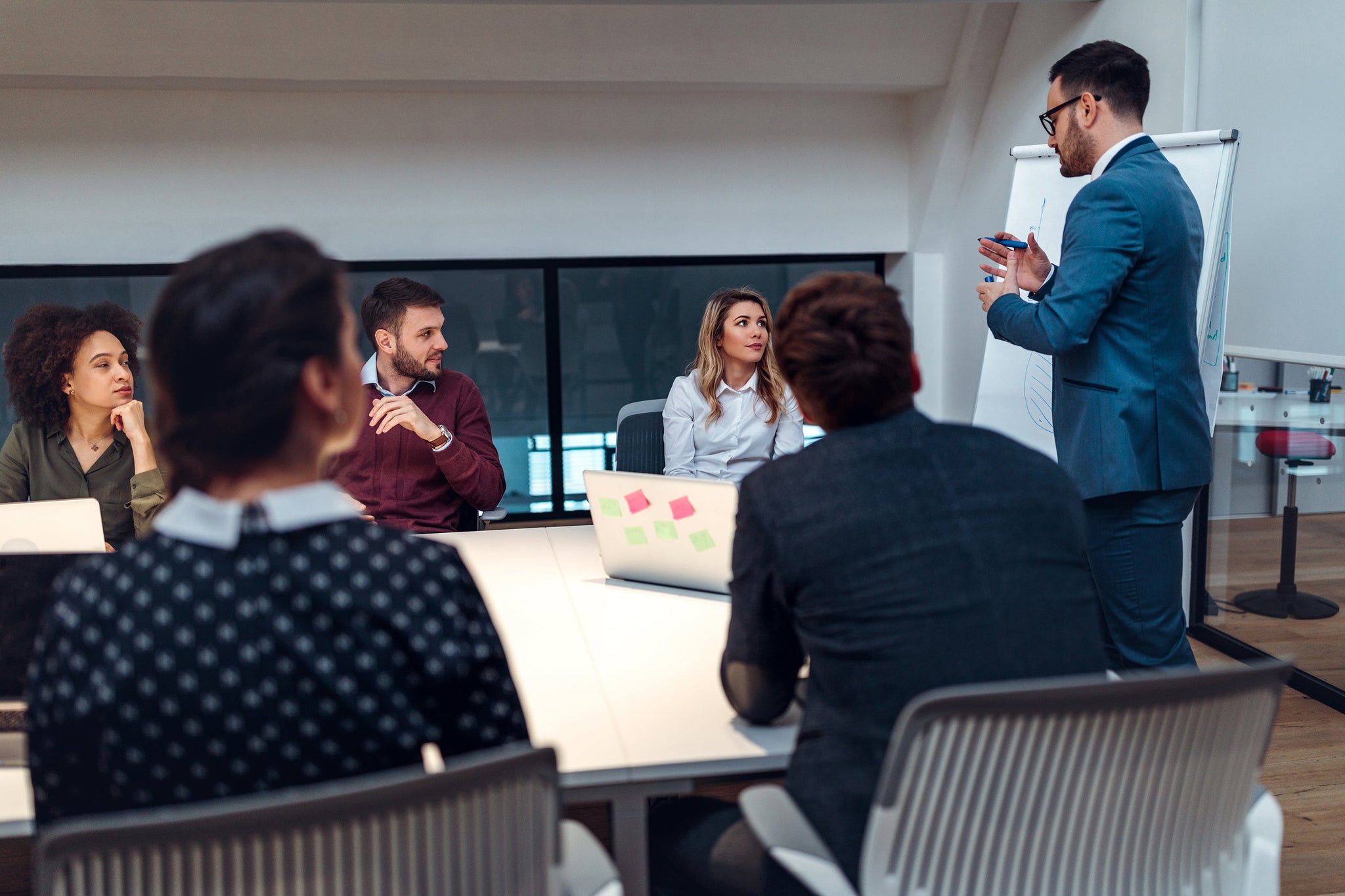 Trainer comparing Train the Trainer benefits and risks - ComplyPlus™ - The Mandatory Training Group UK -
